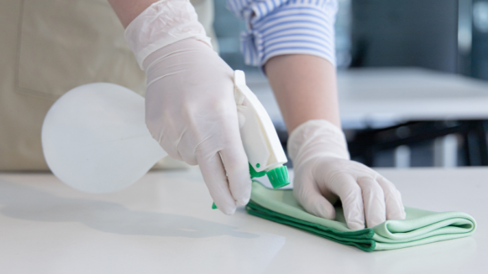 Lady Cleaning Surface With Methylated Spirits