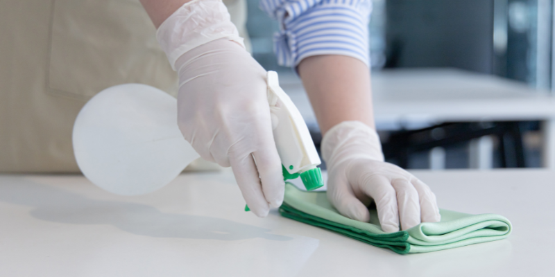 Lady Cleaning Surface With Methylated Spirits