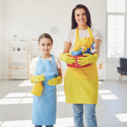 Mother & Daughter Holding Specialised Cleaning Products
